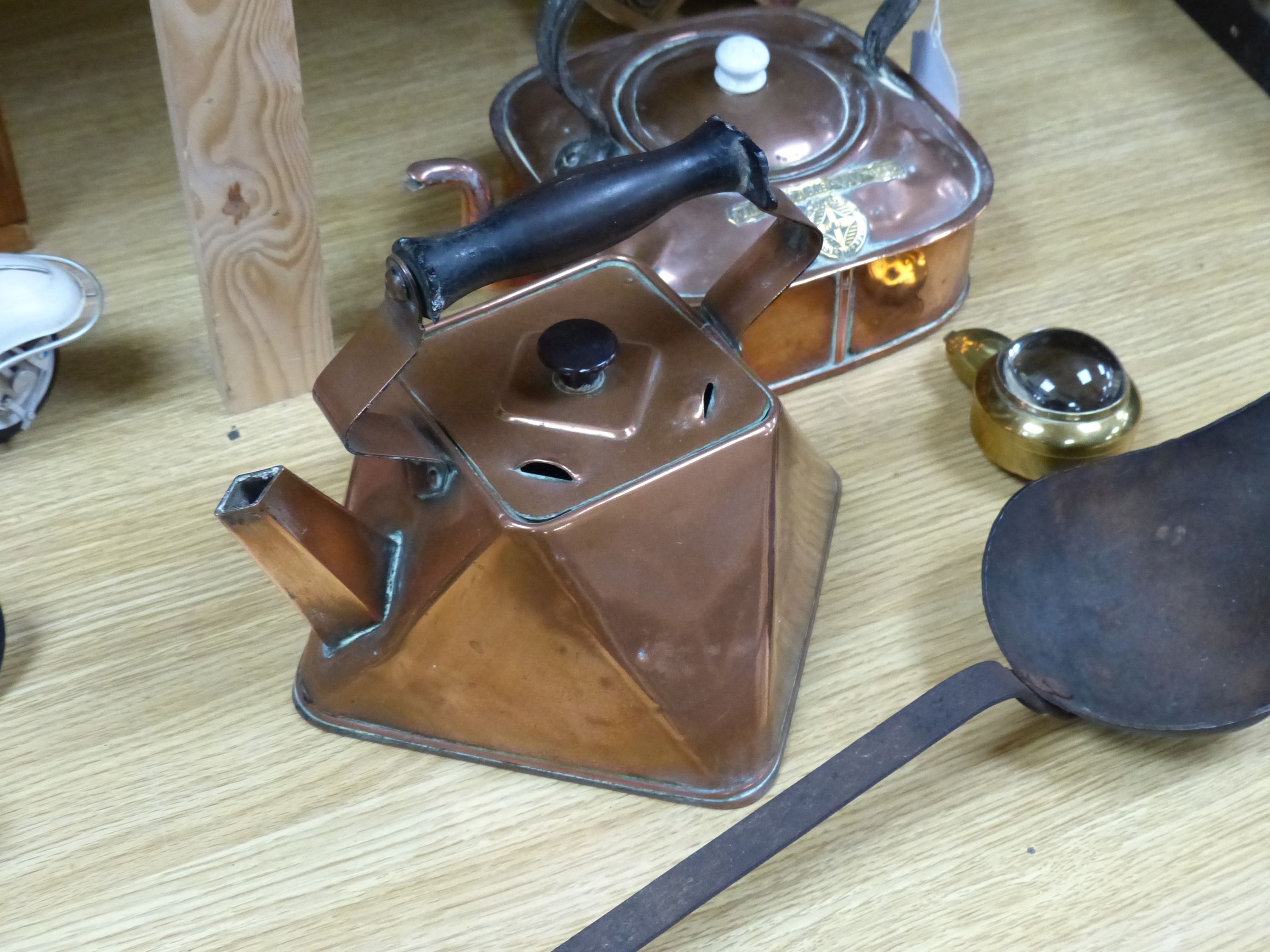 Two copper kettles, a beer slipper, iron ladle and a bull's eye lens